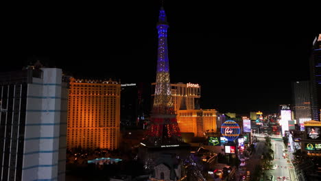 Aerial-rising-tilt-shot-in-front-of-the-night-lit-Eiffel-tower-in-Paris-Las-Vegas