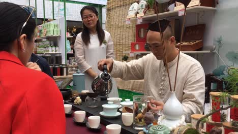 Man-making-tea-in-front-of-customers-in-slow-motion-in-Shanghai,-China