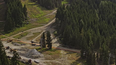 Whistler-BC-Canada-Aerial-v14-zoomed-flyover-downhill-slopes-capturing-mountain-bike-park-trails-and-uphill-chairlift-ride-surrounded-by-lush-coniferous-forest---Shot-with-Mavic-3-Pro-Cine---July-2023