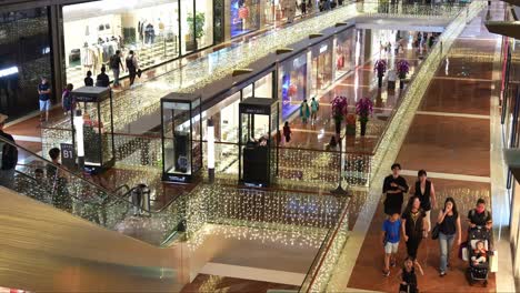 Shoppers-window-shopping-at-landmark-destination-with-luxury-designer-brands-and-premier-stores,-The-Shoppes-shopping-centre-at-Marina-Bay-Sands,-Singapore