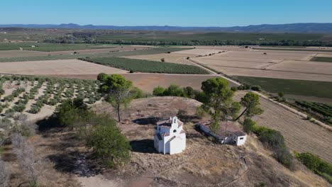 Aerial-of-the-small-church,-La-Ermita-del-Poblado-de-San-Julián,-which-is-a-notable-architectural-and-religious-site-in-the-area