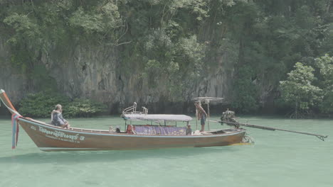 Tourists-on-long-tail-boat-south-of-Thailand-Asia-lagoon-limestone-cliff-prores-video