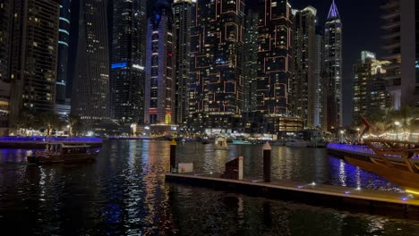 DUBAI,-UAE--04-January-2024:-Night-view-of-Dhow-and-skyscrapers-in-Dubai-Marina---a-residential-neighborhood-and-a-district-in-Dubai,-United-Arab-Emirates