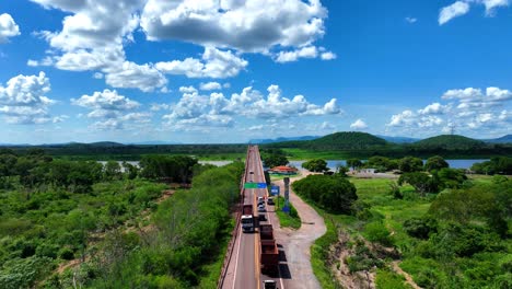 Stunning-drone-video-of-the-Paraguay-River-and-bridge,-showcasing-the-vast-Pantanal-wetlands-under-a-clear-blue-sky