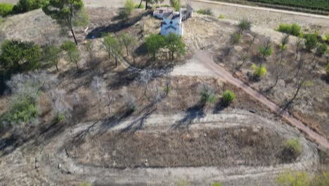 Revealing-aerial-of-the-La-Ermita-del-Poblado-de-San-Julián-,-a-centuries-old-church-nestled-in-the-heart-of-Marmolejo,-radiating-cultural-and-religious-importance