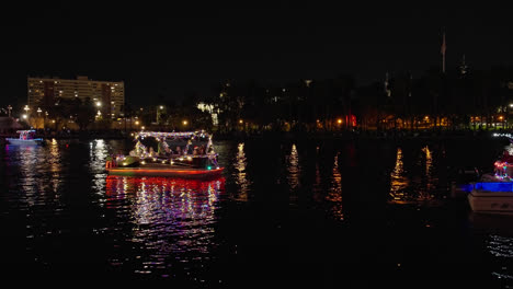 Lights-Flashing-on-Boats-at-Christmas-Boat-Parade-in-Tampa,-Florida