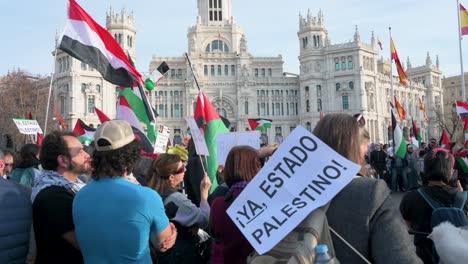 A-protester-holds-a-placard-saying-"Now,-Palestinian-state