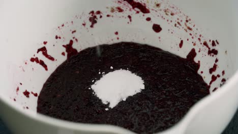 Adding-baking-soda-to-red-velvet-chocolate-beet-muffin-batter-in-white-bowl-for-valentines-day