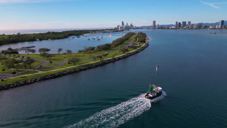 Aerial-views-following-a-trawler-over-the-Broadwater-as-it-returns-to-the-Gold-Coast,-Australia