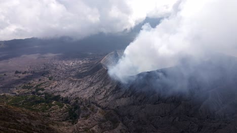 eruption-of-Indonesia's-iconic-and-active-Bromo-Volcano,-dangerous-yet-majestically,-drone-4k-footage,-aerial