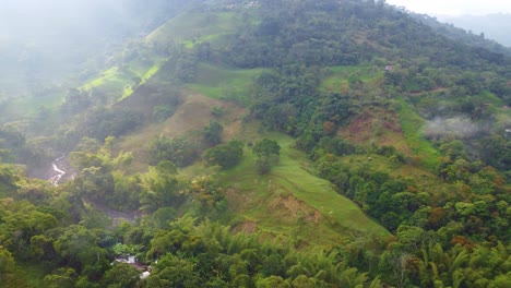 Aerial-view-of-lush,-green-mountains-with-mist,-showcasing-nature’s-serene-and-majestic-beauty