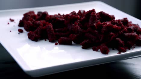 Beet-muffin-pulp-on-rotating-platter-on-white-plate-to-make-red-velvet-beet-pulp-muffin