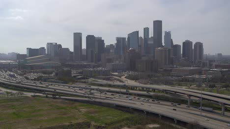 Drone-shot-of-downtown-Houston,-Texas-on-a-high-contrast-sunny-day