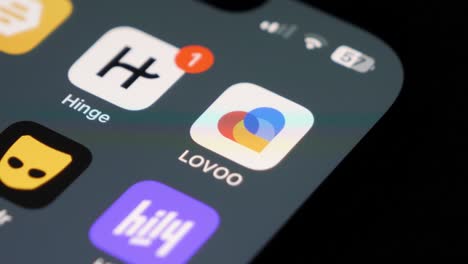 Lovoo-and-Hinge-app-on-smartphone-screen,-Close-up-shot