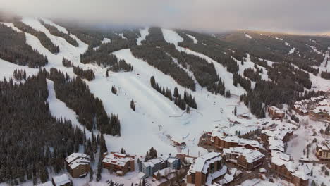 Sun-peaks-foggy-cloud-layer-winter-snowy-early-morning-sunrise-aerial-drone-Copper-Mountain-Colorado-ski-resort-i70-Eagle-Flyer-lift-east-village-snowboarding-half-pipe-Ikon-Epic-pass-forward-pan-up