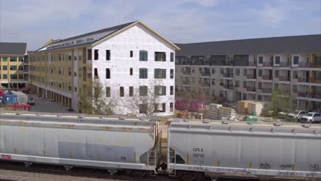 Drone-view-of-new-housing-construction-as-train-passes-by