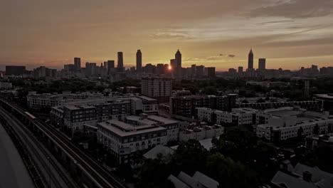 Atlanta-Georgia-Aerial-v915-cinematic-drone-flyover-Husley-Yard-at-O4W-towards-Sweet-Auburn-capturing-downtown-cityscape-on-the-skyline-with-golden-sunset-sky---Shot-with-Mavic-3-Pro-Cine---May-2023