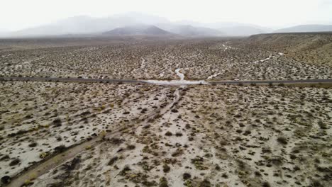 aerial-view-captures-the-shifting-shadows-over-the-mountains-of-California's-Anza-Borrego-State-Park,-showcasing-the-vastness-of-the-landscape