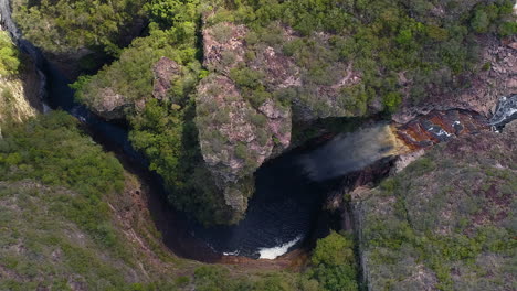 Aerial-view-of-a-waterfall-and-a-river-in-the-middle-of-a-big-vegetation,-Chapada-Diamantina,-Bahia,-Brazil