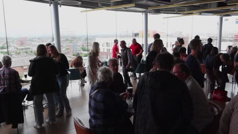 Crowded-Gravity-Bar-with-360-degree-view-of-Dublin-City-through-glass-walls-in-daytime