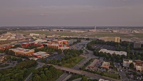 Atlanta-Georgia-Aerial-v963-establishing-drone-flyover-Hapeville-capturing-Hartsfield-International-Airport-featuring-Delta-World-HQ-campus-ground-at-sunset---Shot-with-Mavic-3-Pro-Cine---June-2023