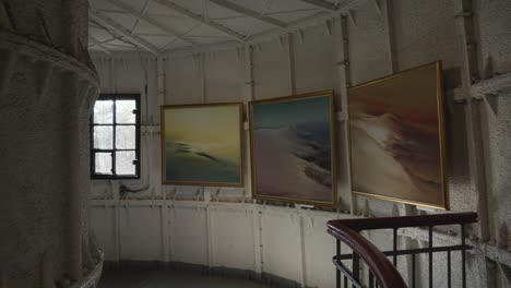 An-exhibition-of-paintings-inside-the-Stilo-lighthouse-in-Poland,-showcasing-art-amidst-the-maritime-setting