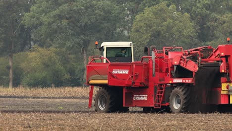 Fixed-frame-with-heavy-machinery-crop-harvester-in-farmland-soil-entering