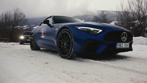 Low-angle-view-of-cars-in-line-to-enter-winter-drift-event-race-track