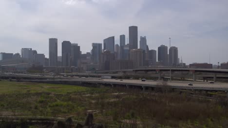 Drone-shot-of-downtown-Houston,-Texas-on-a-high-contrast-sunny-day