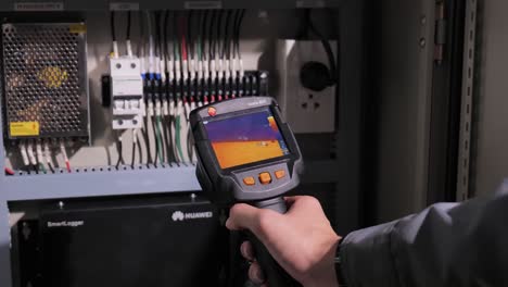 Technician-Use-Thermoscan-Checking-the-Heat-of-Main-Supply-Box,-Close-Up