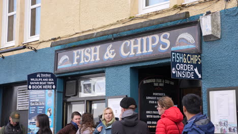 People-in-Front-of-Fish-and-Chips-Fast-Food-Restaurant-in-Portree,-Isle-of-Skye