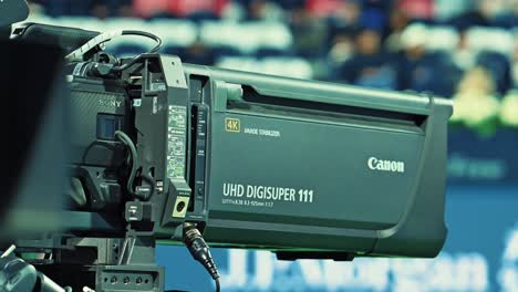 A-Canon-sports-4K-premium-quality-super-zoom-lens-in-operation-during-a-tennis-sporting-event-in-Dubai,-UAE