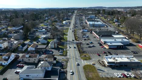 Driving-cars-on-main-road-between-Stores-and-American-Neighborhood