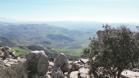 Aerial-drone-footage-captures-the-stunning-landscape-of-Torcal-de-Antequera,-focusing-on-the-unique-rock-formation-known-as-"El-Casco