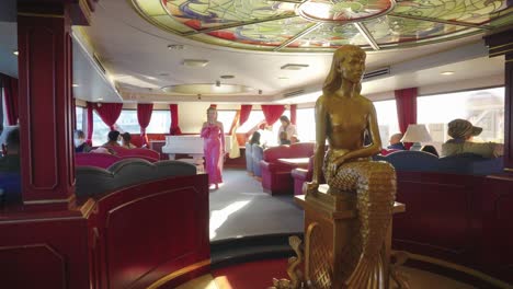 Slow-motion-pan-through-beautiful-Interior-of-Boat-with-Mermaid-statue-and-statue-of-singer