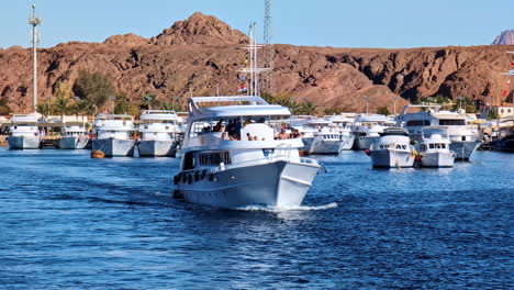 Tourists-on-vacation-sailing-through-the-Red-sea,-sunny-day-in-Egypt-along-coastal-strip