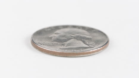 Washington-quarter-coin-Laid-Flat-On-White-Table