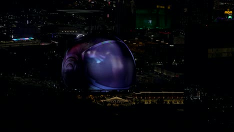 Sphere-Las-Vegas-with-glowing-abstract-display-at-night-from-high-angle