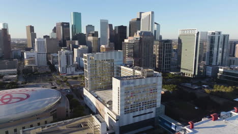 Drone-shot-around-the-Hilton-Americas-Houston-hotel,-sunny-morning-in-Texas,-USA