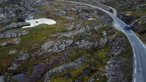 Aerial-footage-of-blue-van-on-small-road-in-Norway