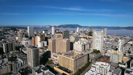 Drone-Shot-of-San-Francisco-USA-Nob-Hill-Neighborhood,-Historic-and-Modern-Building-With-Bay-and-Golden-Gate-Bridge-in-Background