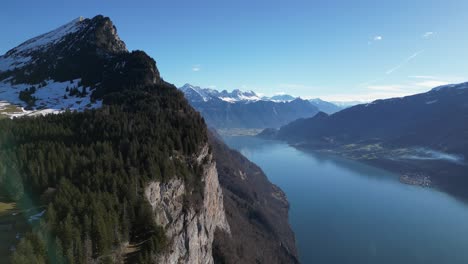 Amden-Weesen-Switzerland-aerial-flight-along-the-cliffs-of-famous-majestic-lake-golden-hour