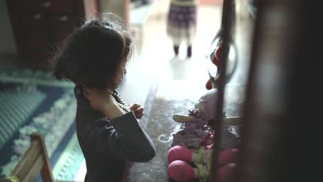 Little-Girl-Playing-with-Doll-in-a-Home-Setting