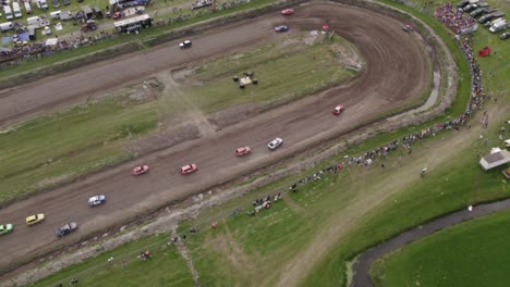 Aerial-view-of-old-cars-racing-on-dirt-track,-Friesland,-Netherlands