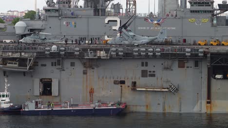 Helicopter,-equipment-and-people-onboard-battleship-USS-Kearsarge