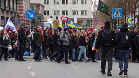 Side-view-of-protesters-marching-against-Covid-regulations,-Stockholm