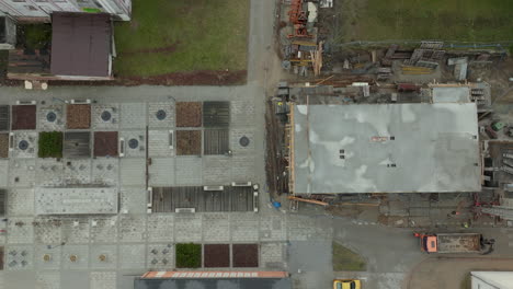 Aerial-top-down-shot-crane-in-residential-area-of-polish-city-at-cloudy-day