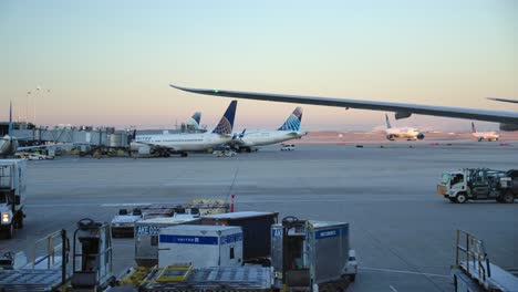 Airplanes-and-Ground-Vehicles-Movement-at-the-Airport,-Static,-Sunset