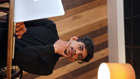 Vertical-shot-of-Sri-Lankan-designer-working-on-his-laptop-at-coffee-shop