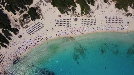 Orbiting-drone-shot-slowly-descending-above-the-Cala-Agulla-bay,-in-the-Llevant-Penisula-located-in-the-Mediterranean-island-of-Mallorca-in-Spain